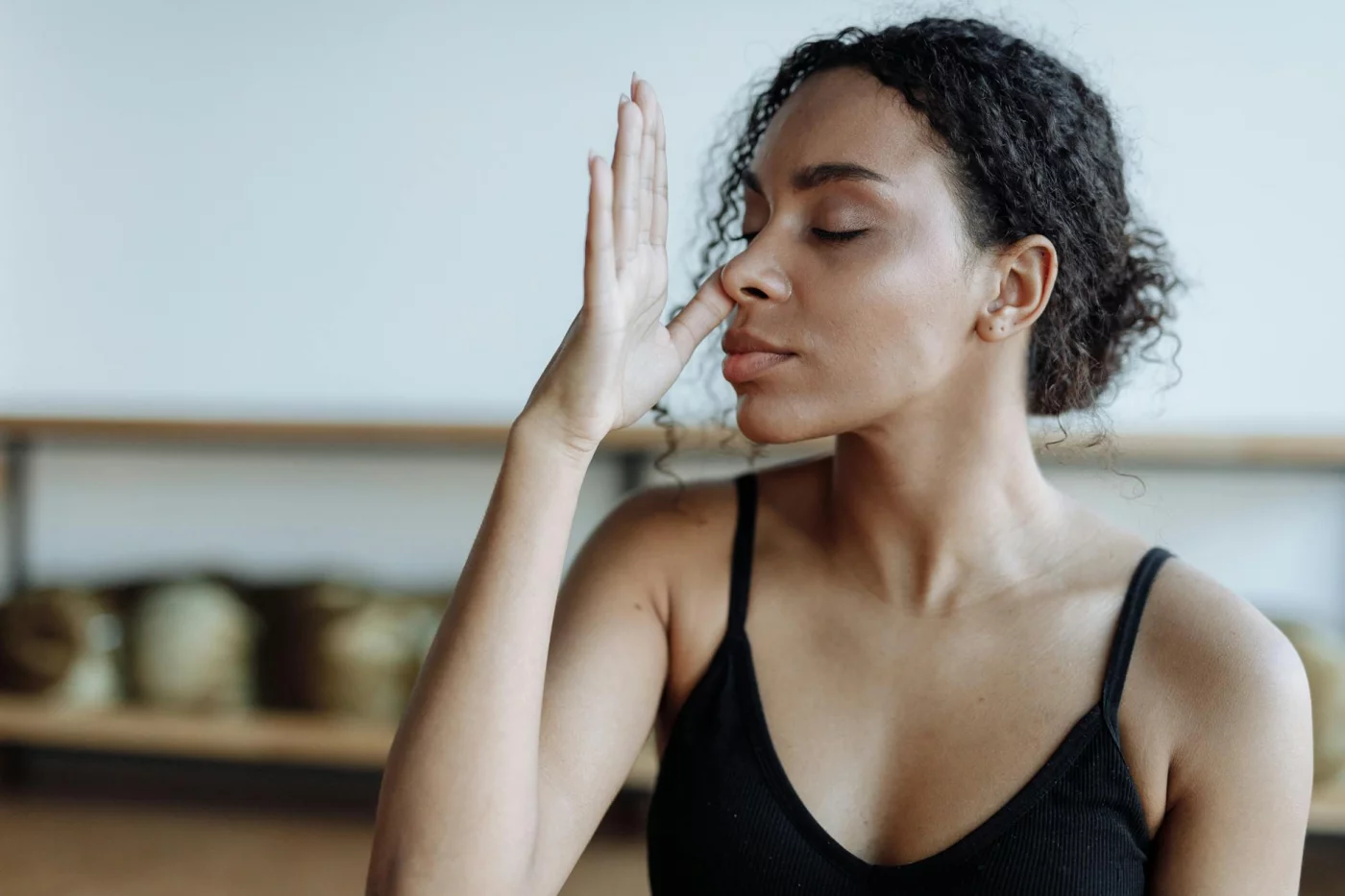 7 Evidence-Based Breathing Exercises for Stress and Focus Woman practicing yoga breathing exercises for beginners indoors to relax and reduce stress