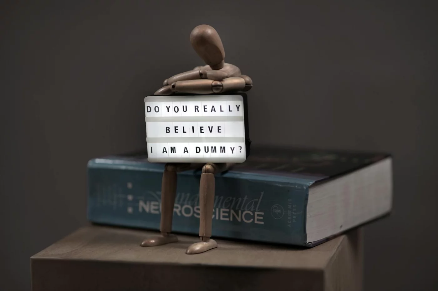Do We Use Only 10 Percent of Our Brain? The Myth, Explained Clearly Wooden mannequin with a letter board asks, do we use only 10 percent of our brain, beside a neuroscience book