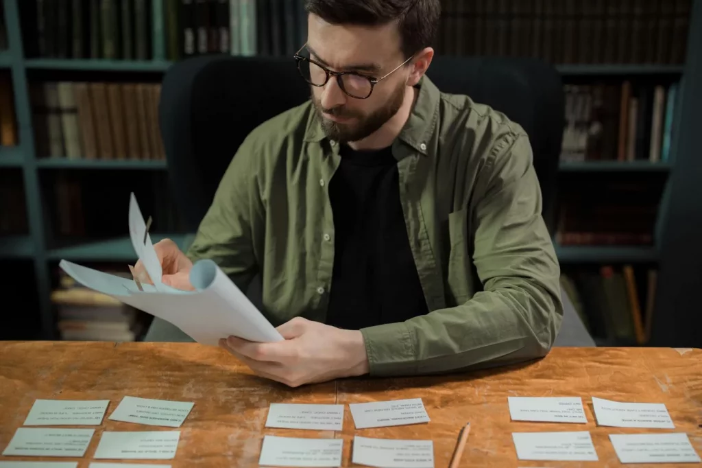 Dual N-Back Training: Does It Really Increase IQ? Researcher reviewing papers in a library while exploring does dual n back increase iq and cognitive training claims