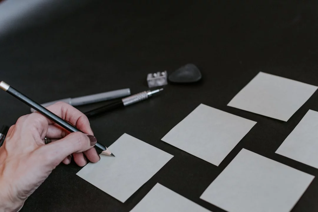 Dual N-Back Training: Does It Really Increase IQ? Person drawing squares on a table to illustrate how dual n-back works and why does dual n back increase iq is debated