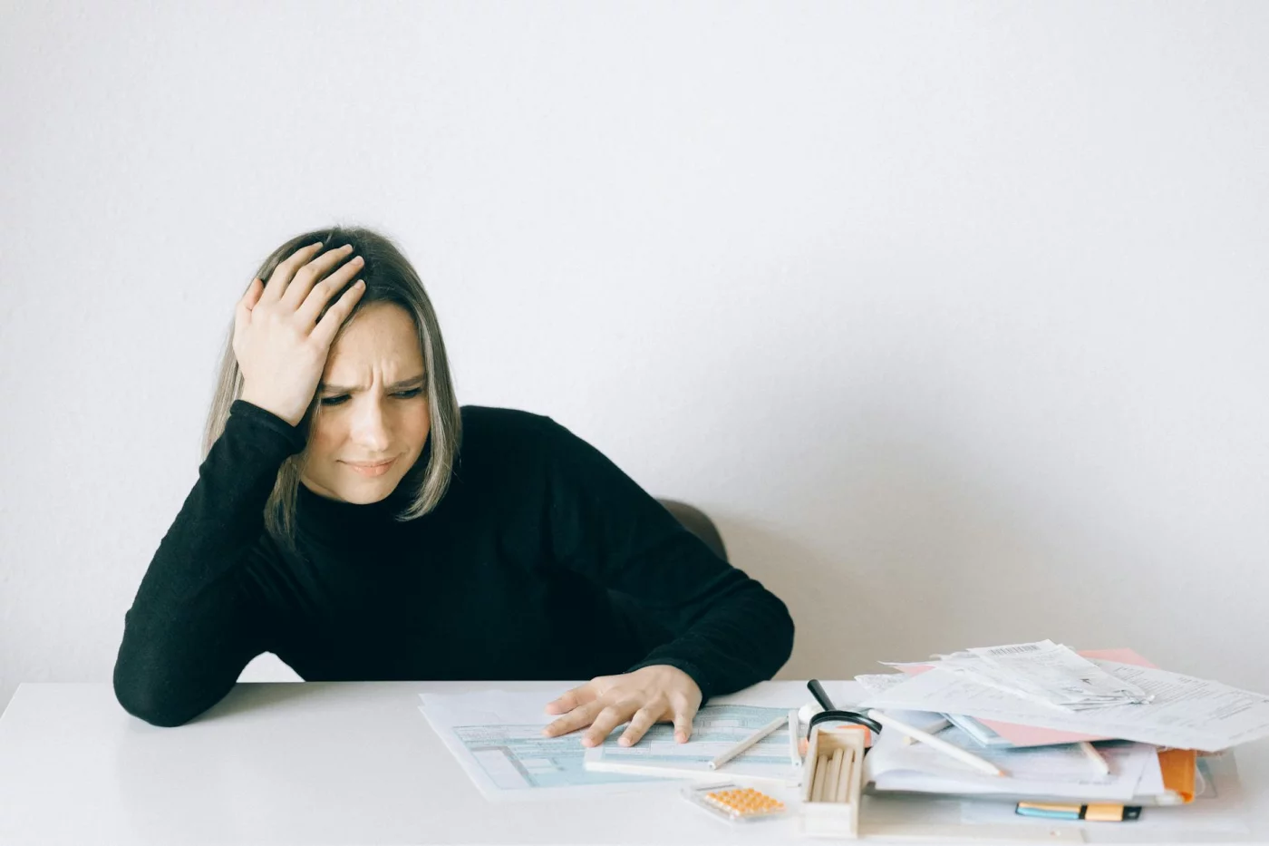 Does Stress Affect Memory Recall? A Practical 7-Step Guide Woman overwhelmed by financial paperwork, showing how does stress affect memory recall and focus at work