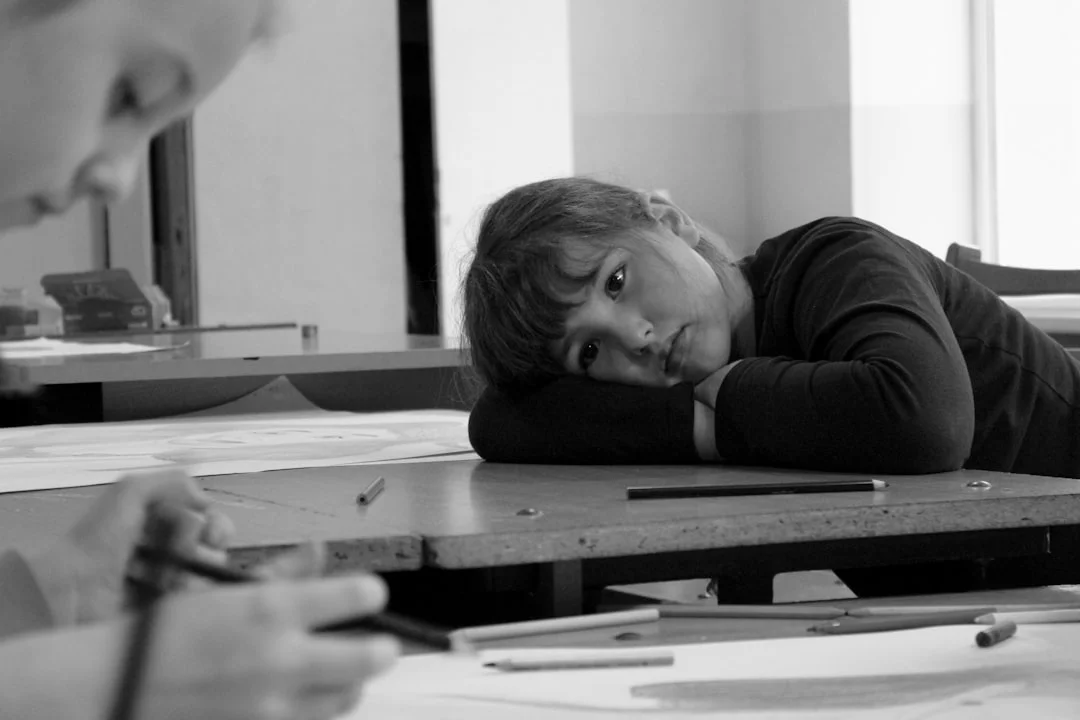 How Test Anxiety Affects Students and Which Study Skills Help Most Young girl resting on a table with a pencil, illustrating the effects of test anxiety on students
