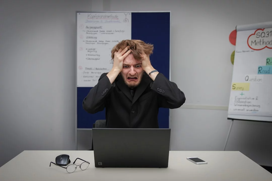 Task Aversion vs Laziness: How to Tell What’s Really Going On Man sitting at a laptop, illustrating executive dysfunction vs laziness in ADHD, anxiety, and burnout