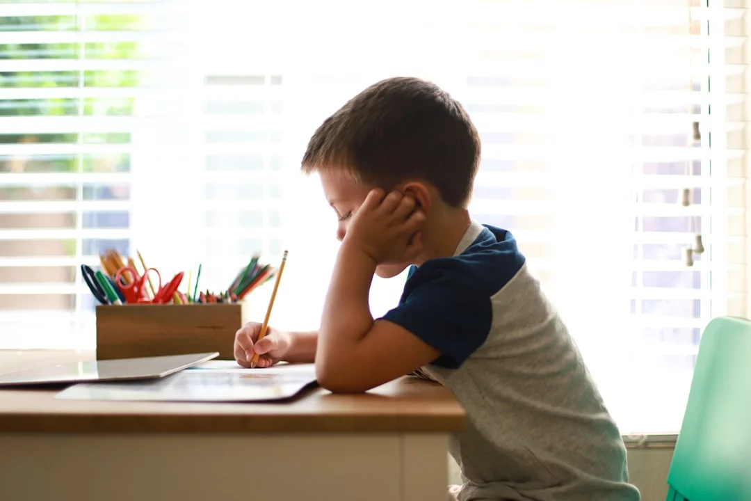 Task Aversion vs Laziness: How to Tell What’s Really Going On Young boy at a desk writing a next-steps list for executive dysfunction vs laziness