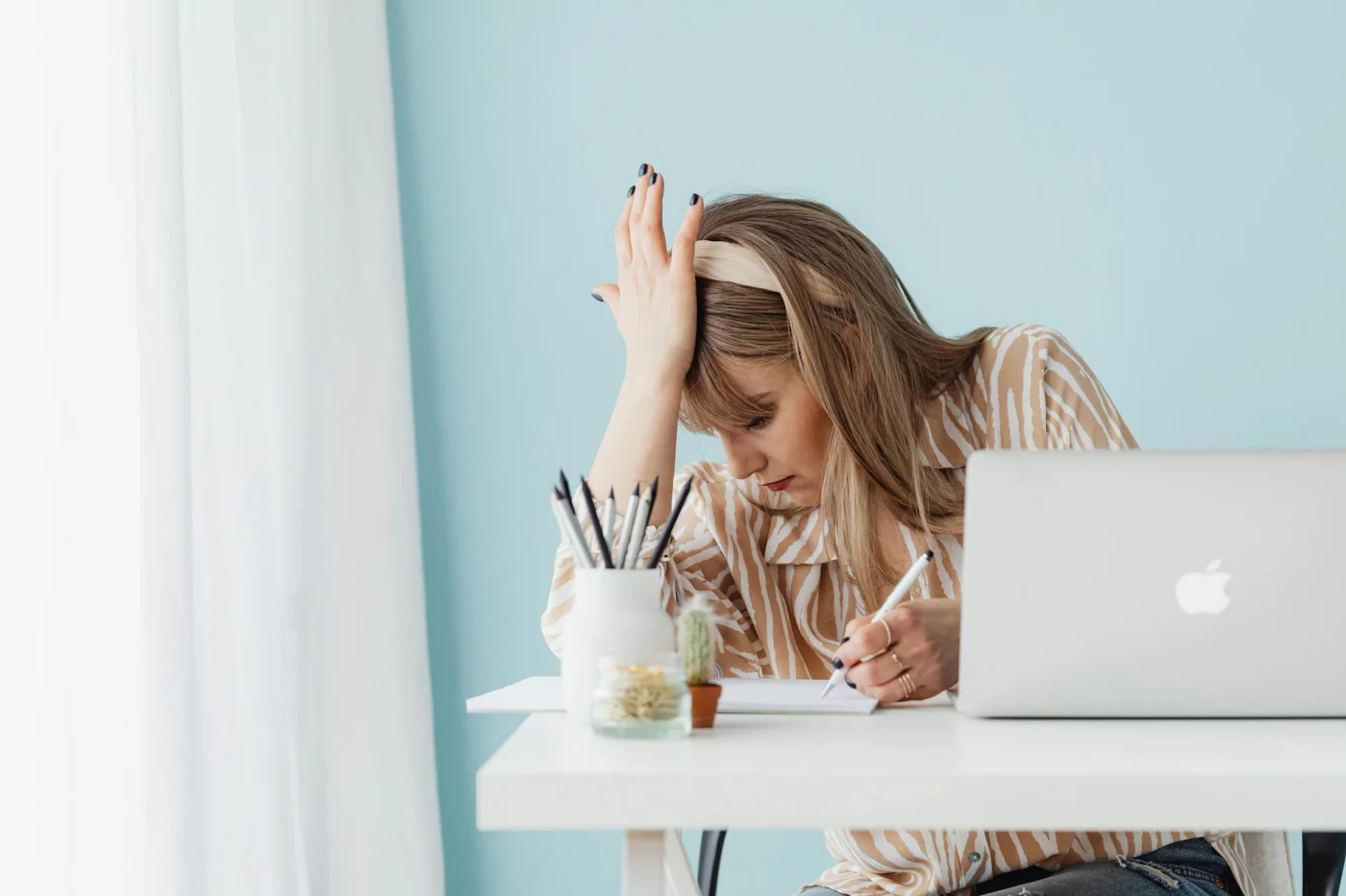 Expressive Writing for Stress: A Practical 4-Step Method Woman feeling stressed at her laptop, illustrating when expressive writing therapy may help manage emotions