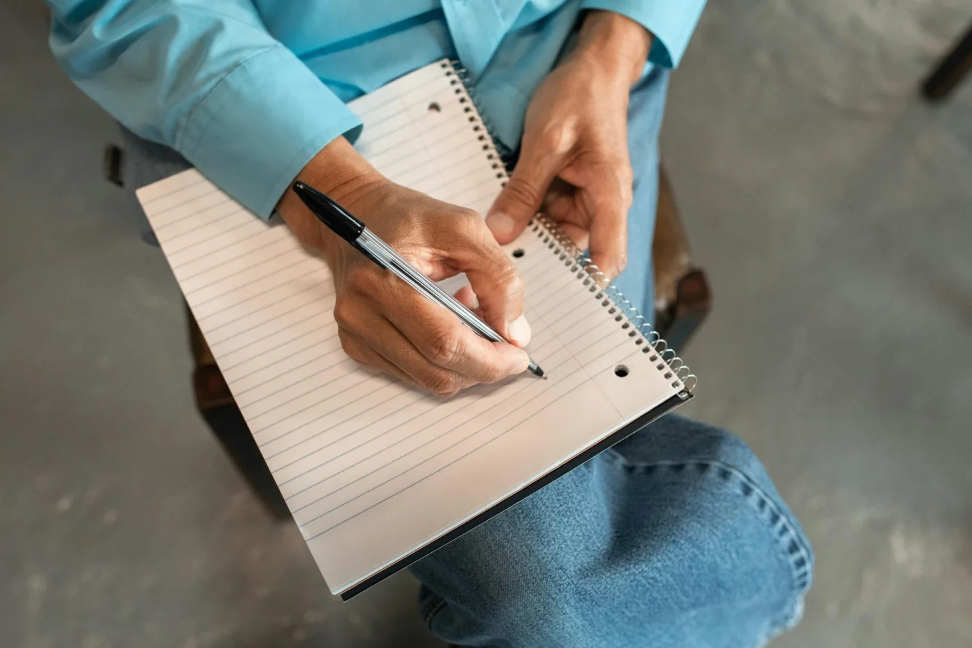 Expressive Writing for Stress: A Practical 4-Step Method Hands writing in a spiral notebook, illustrating the 4-step expressive writing therapy method