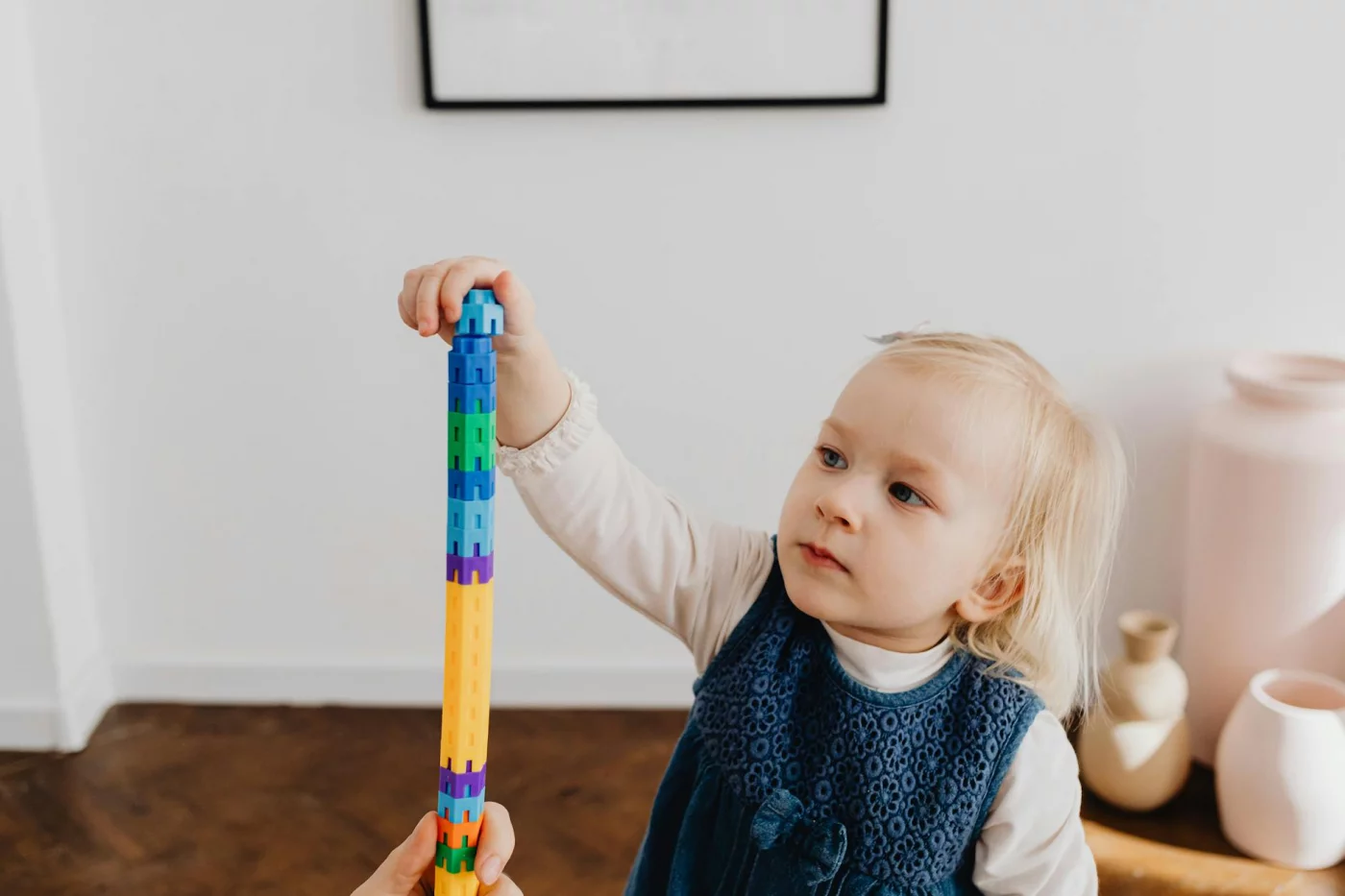 Fine Motor Skills vs Gross Motor Skills: 7 Proven Ways Adults Learn Faster Toddler stacking colorful blocks at home, introducing fine motor skills vs gross motor skills through play