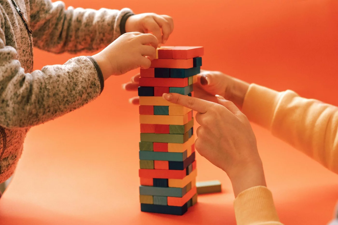 Fine Motor Skills vs Gross Motor Skills: 7 Proven Ways Adults Learn Faster Adult and child stacking wooden blocks to explore fine motor skills vs gross motor skills through play