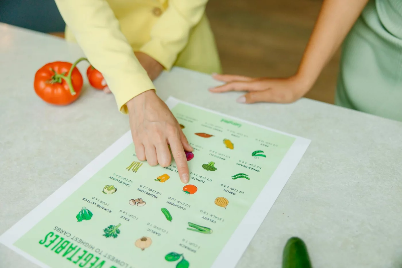 How to Reduce Oxidative Stress for Better Brain Health and Memory Hands pointing to a vegetable nutrition chart with tomatoes, highlighting foods that reduce oxidative stress