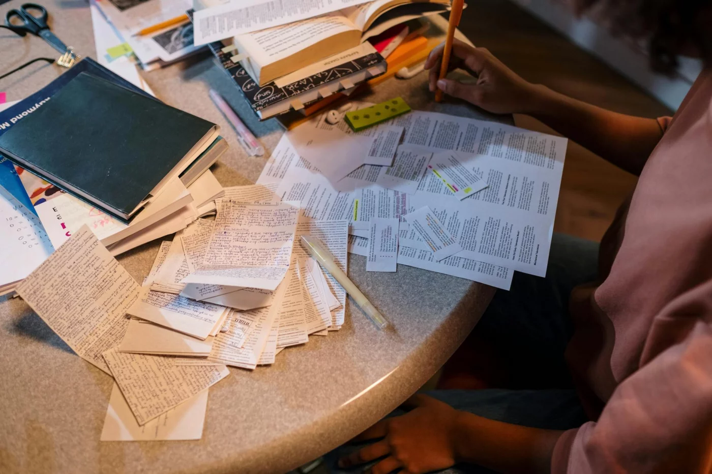 Student sorting notes and books for exams while planning google drive organization for students