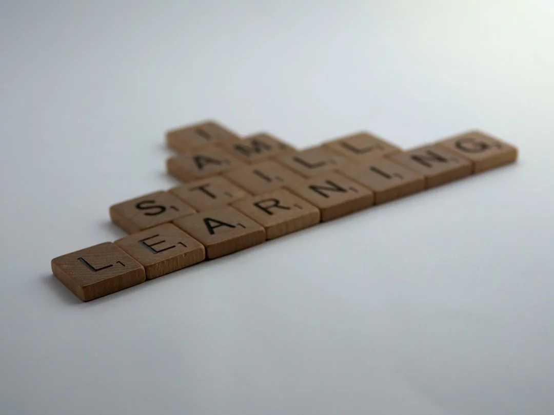 Brown wooden blocks on a white surface illustrating how does attention affect learning through focus and organization