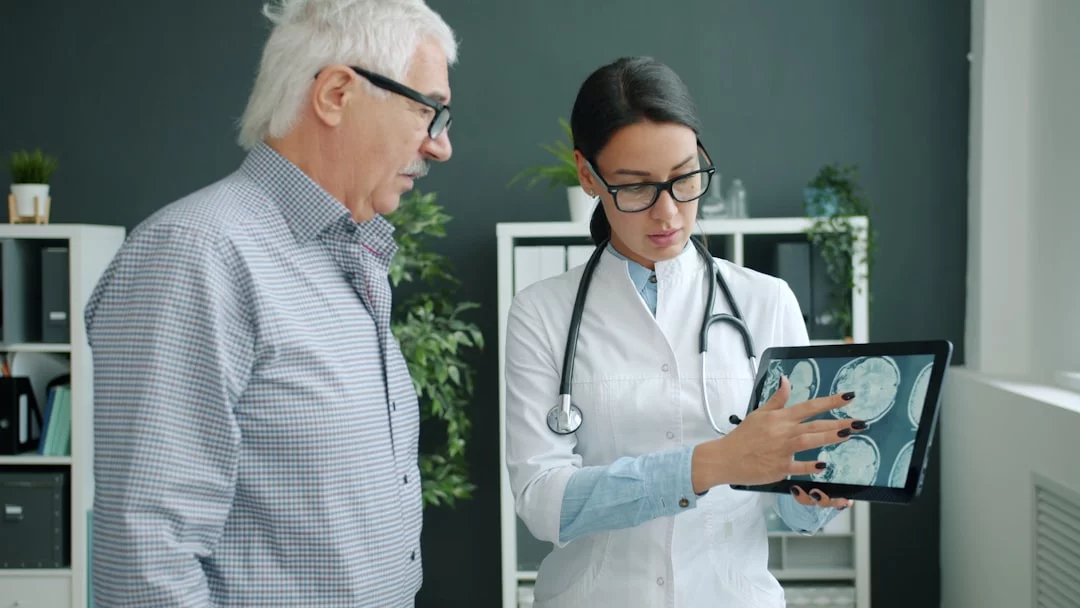 How the Hippocampus Shapes Learning, Memory, and Recall Doctor shows a brain scan to an elderly patient while explaining how does the hippocampus affect memory