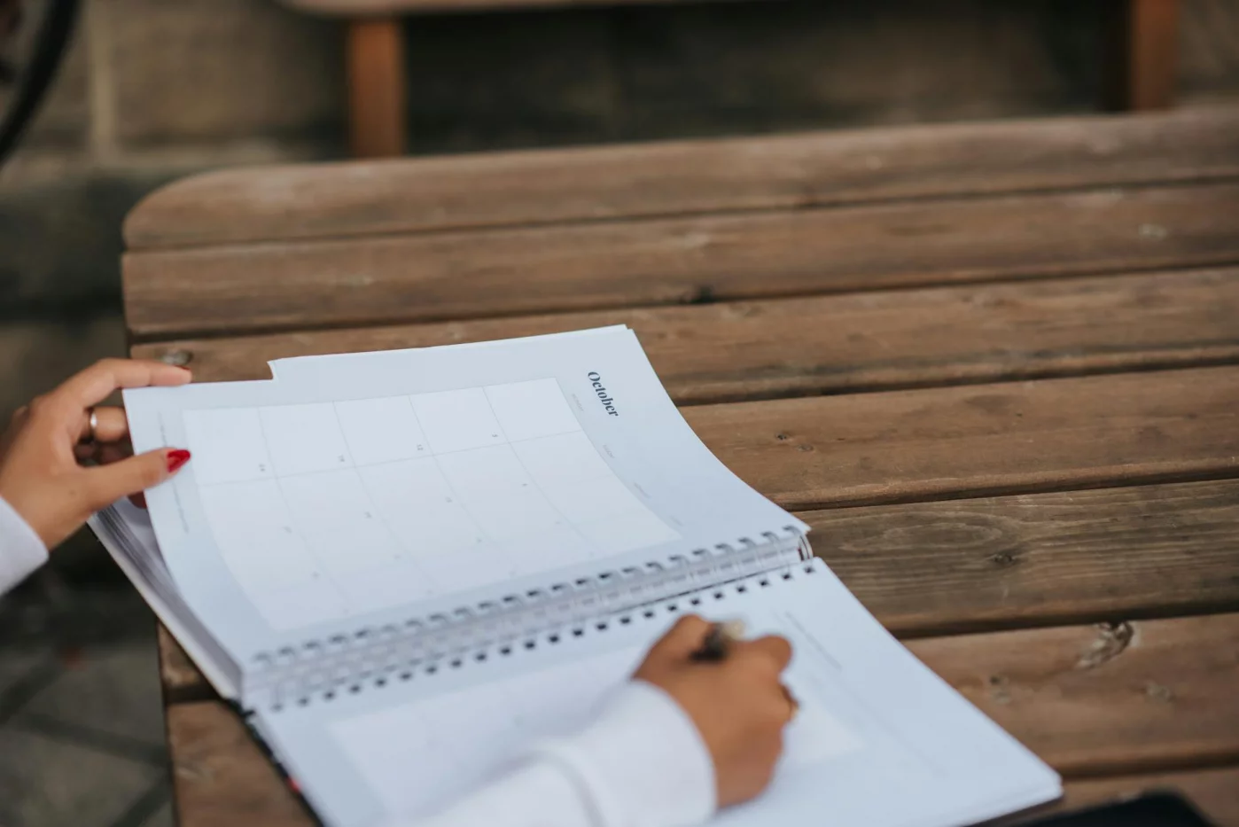 How to Learn Better Right Now With 7 Science-Backed Methods Student writing study plans in a planner outdoors, exploring how to learn better through organized practice