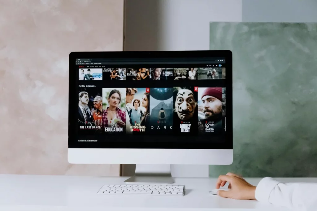 Modern workspace with Netflix series on screen, illustrating how to learn language with netflix at home