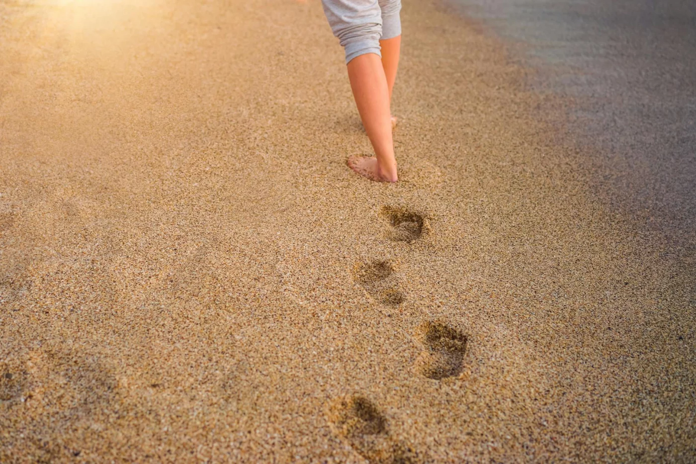 How to Meditate While Walking: A Beginner-Friendly Daily Practice Barefoot walker on a sandy beach at sunset shows how to meditate while walking in everyday life