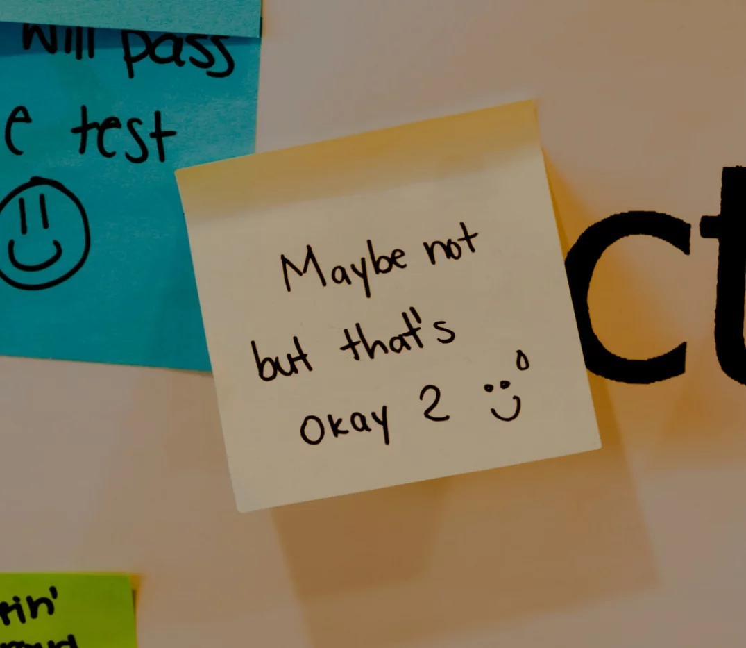 Sticky note on a bulletin board highlighting a key trigger in learning how to overcome procrastination