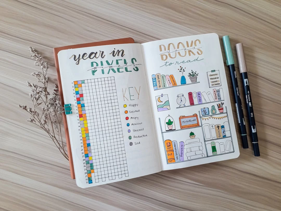 How to Read 50 Books a Year While Working Full-Time Bullet journal with planner and markers illustrating how to read 50 books a year in 7 smart steps