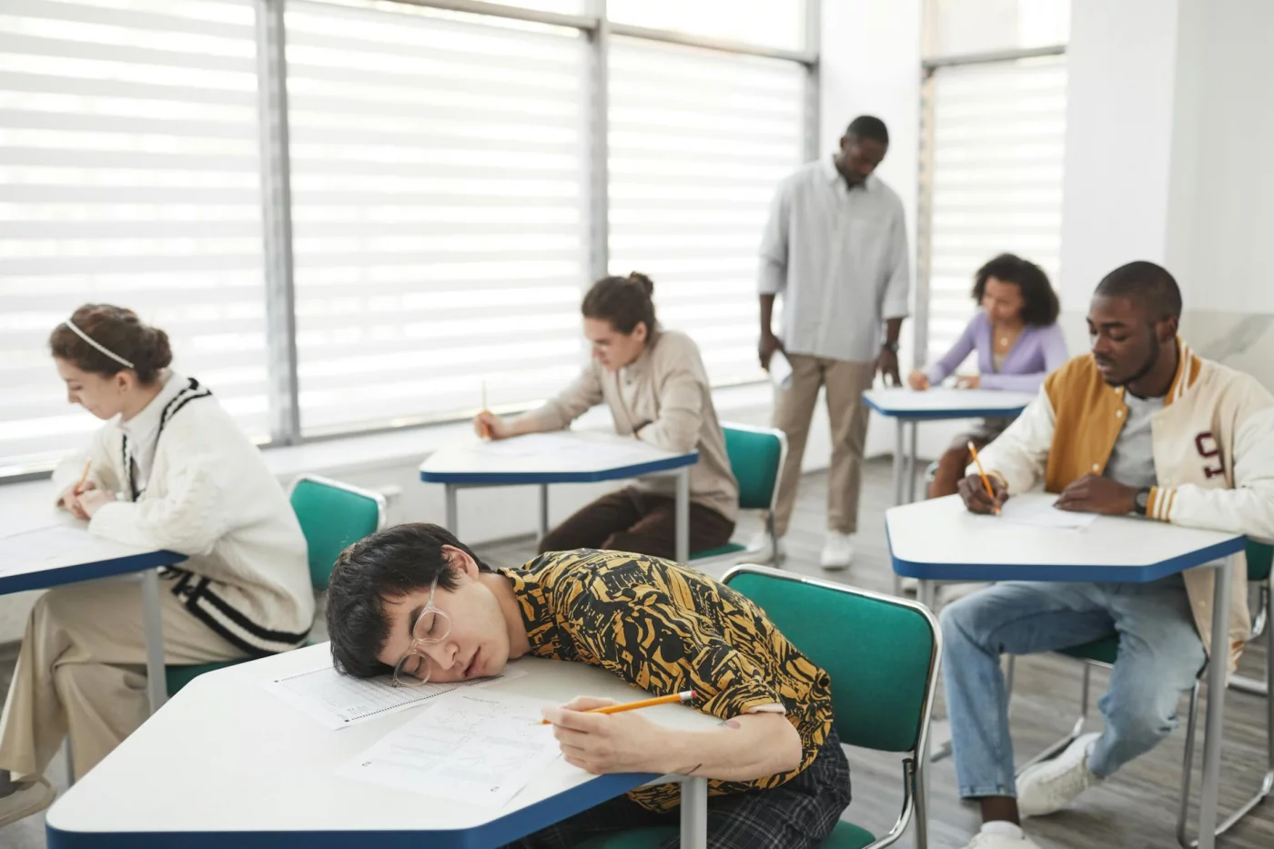 How to Reduce Stress Before a Test Without Wrecking Memory Recall Students taking an exam in a focused classroom, illustrating how to reduce stress before a test