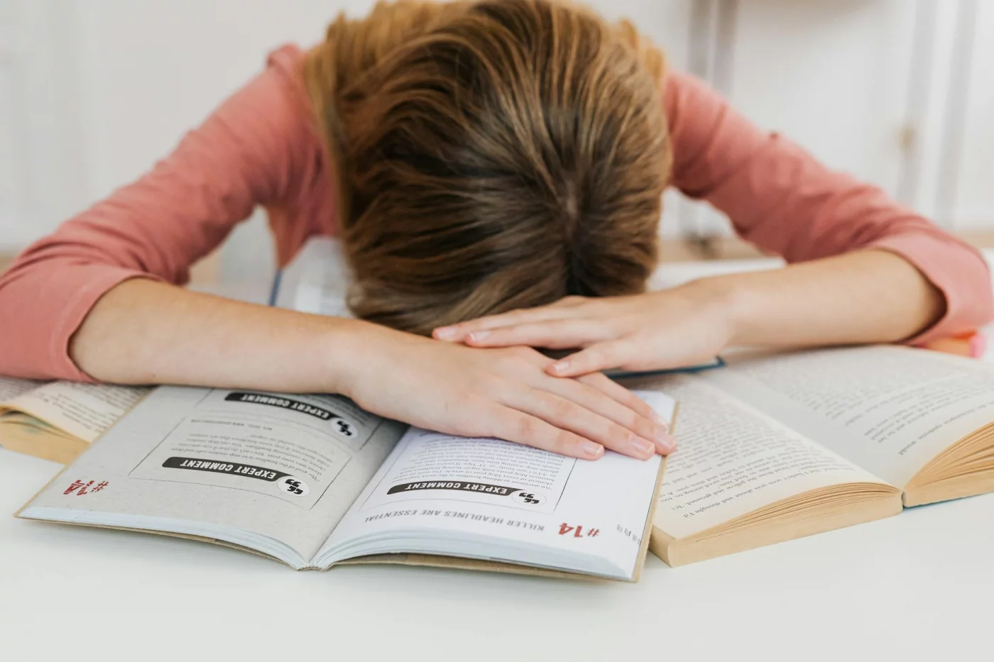 How to Reduce Stress Before a Test Without Wrecking Memory Recall Student asleep over open books shows common mistakes in how to reduce stress before a test