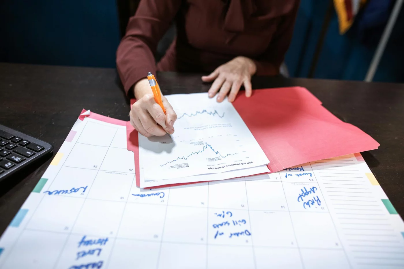 How to Study for the CPA Exam While Working: An 8-Step Plan Calendar and financial notes on an organized desk showing how to study for CPA exam while working and plan retakes