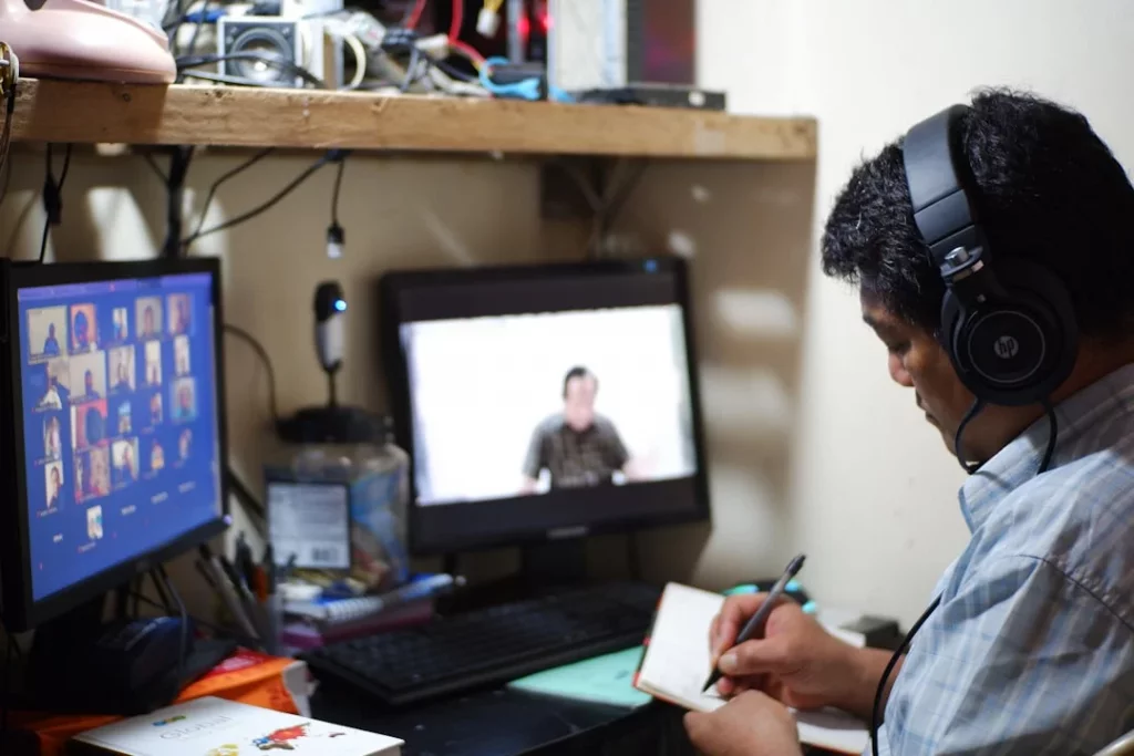 Student reviewing notes on paper while learning how to take notes from video lectures effectively