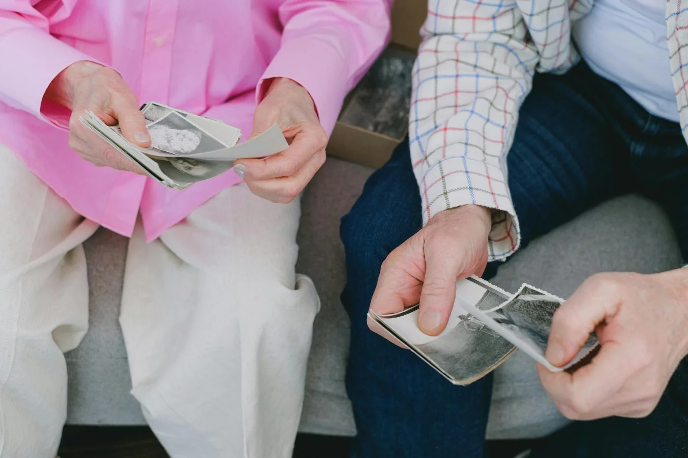 Is Memory Loss a Normal Part of Aging? 7 Research-Backed Answers Senior couple looking through vintage photos while asking, is memory loss a normal part of aging?