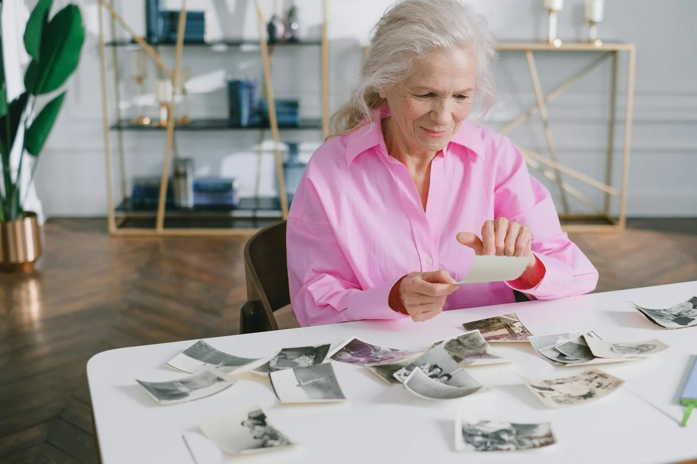 Is Memory Loss a Normal Part of Aging? 7 Research-Backed Answers Senior woman looking through old photographs while asking, is memory loss a normal part of aging?