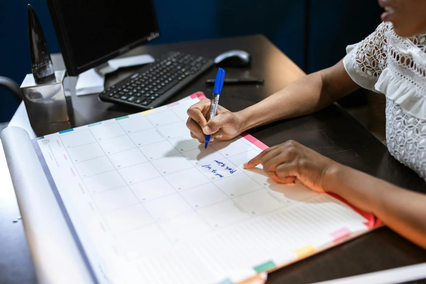 Person planning a 60-minute deep work block in a desk calendar, showing is time blocking good for adhd
