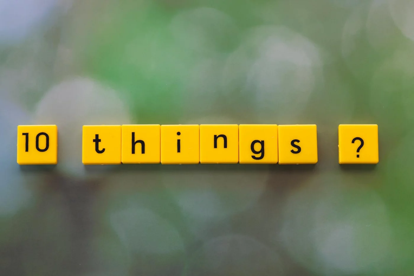 Peg System Memory Technique: How to Remember Lists and Numbers Yellow tiles spelling '10 things?' illustrate the peg system memory technique on a green blurred background