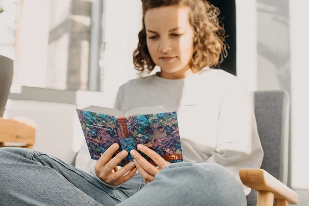 7 Signs Your Brain Is Rewiring and Why It Matters Woman sitting in a chair reading a book during an FAQ on signs your brain is rewiring