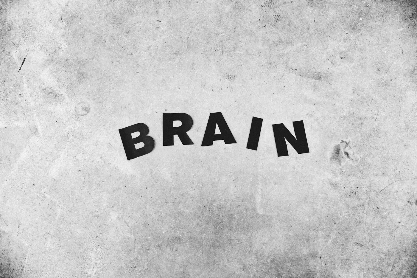 What Is an Engram? 7 Clear Facts About Memory Traces Brain title on a rough gray wall illustrating what is an engram in psychology, hippocampus, neurons, and synapses