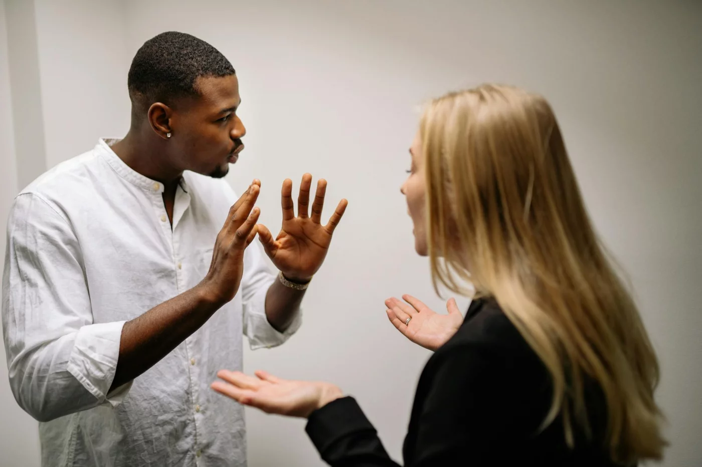 Amygdala Hijack Explained: What It Is and How to Calm It Frustrated coworkers in a heated office discussion illustrating what is the amygdala hijack in conflict