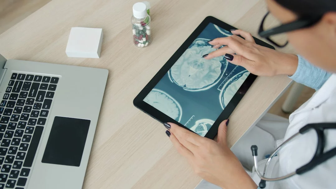What the Neuroscience Education Institute Is and Why It’s Trending Doctor reviewing a brain scan on a tablet to explain what is the neuroscience education institute and what does it do