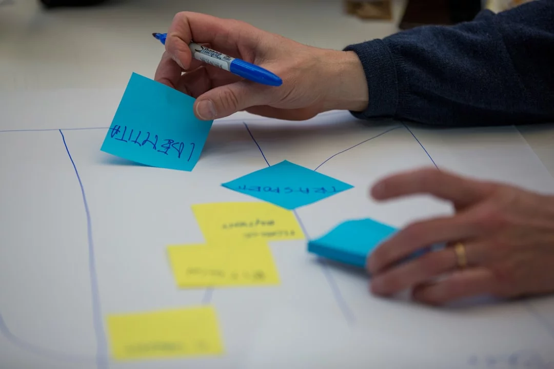 Zettelkasten for Students: 7 Smart Steps for Notes, Revision, and Writing Student writing notes on white paper with a blue pen, illustrating the zettelkasten method for students