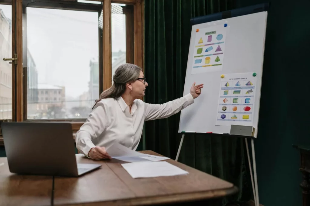 Senior woman teaching a geometry lesson online, representing free online courses for seniors