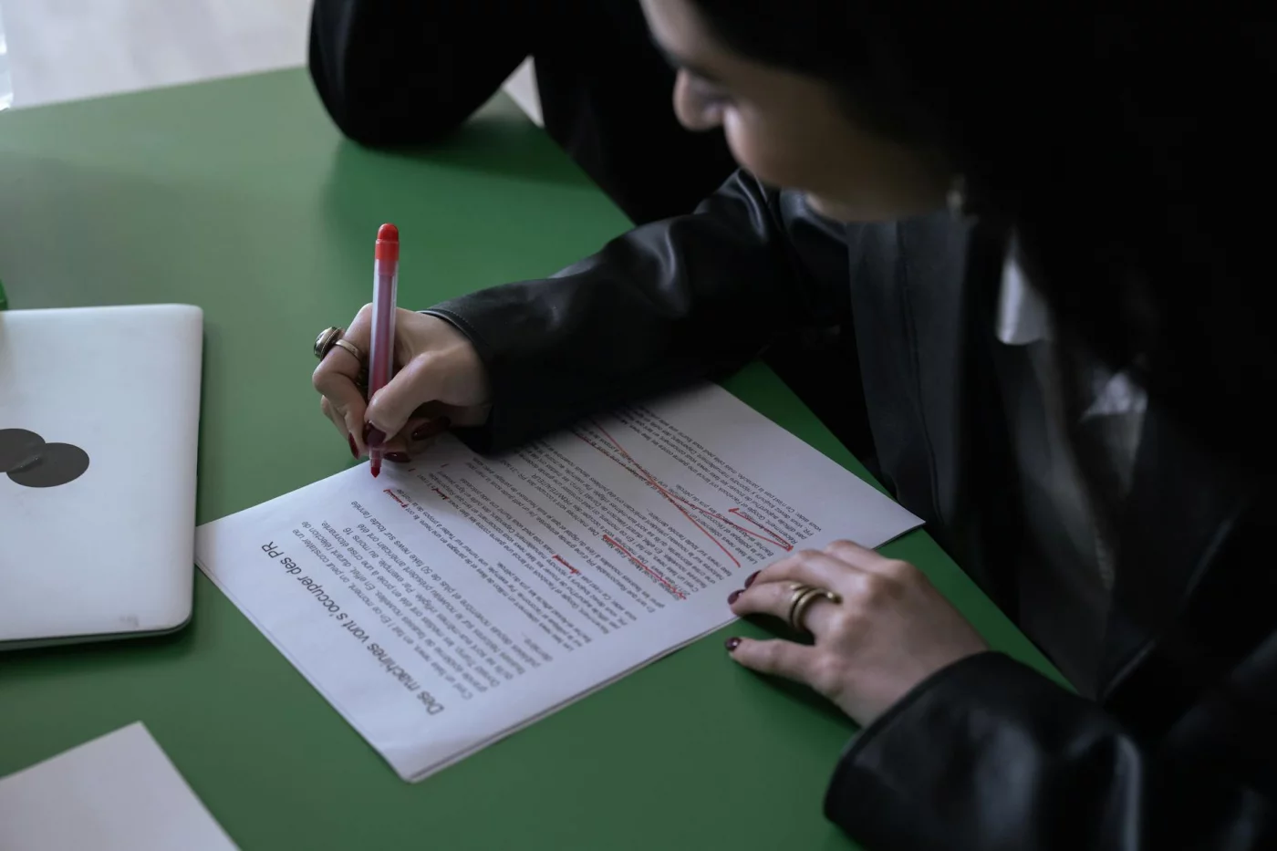 Editor marking a research document with a red pen, showing how to read scientific papers quickly and critically