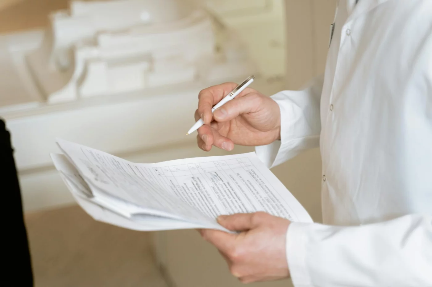 Doctor reviewing medical documents for FAQs on how to read scientific papers quickly and critically