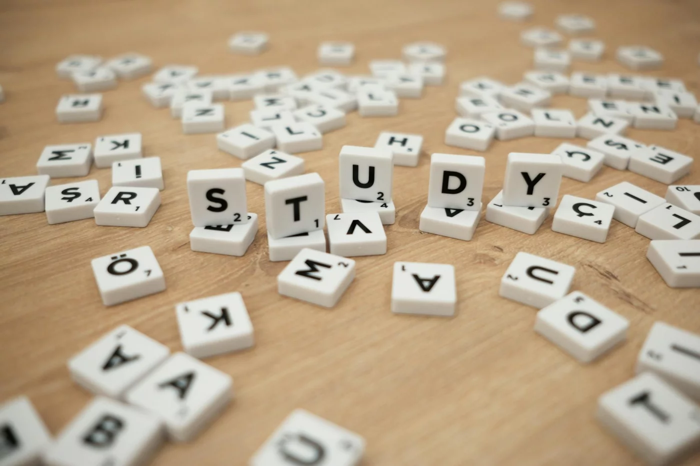 Study letter tiles on a wooden surface illustrating how to use TV shows to learn a language effectively