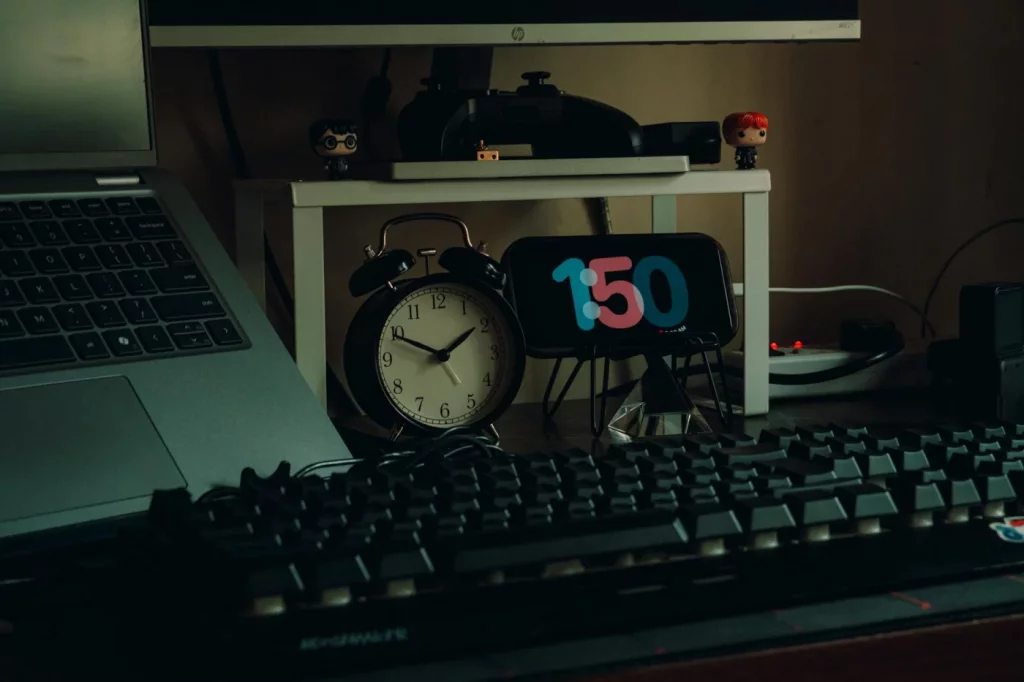 Modern home office workspace with laptop and clock, ideal for studying the peg system 1-100