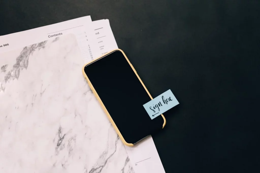 Black smartphone on a white notepad illustrating what are tags in notes for practical exam revision