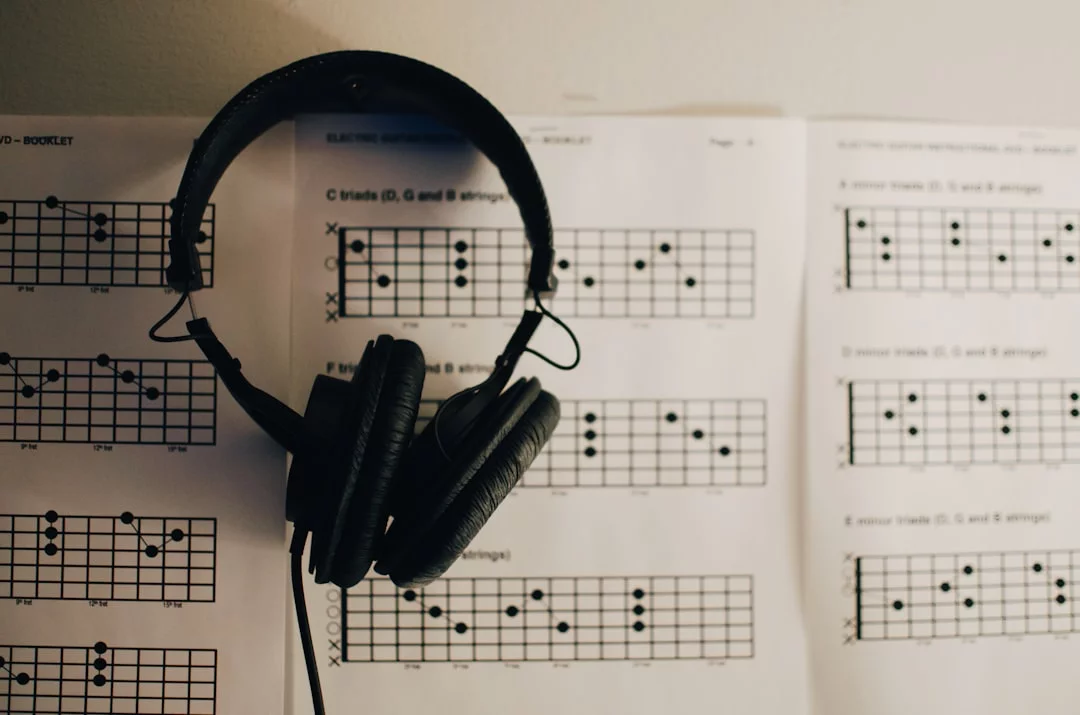FAQ graphic for what music should you listen to while studying, featuring black headphones on white paper