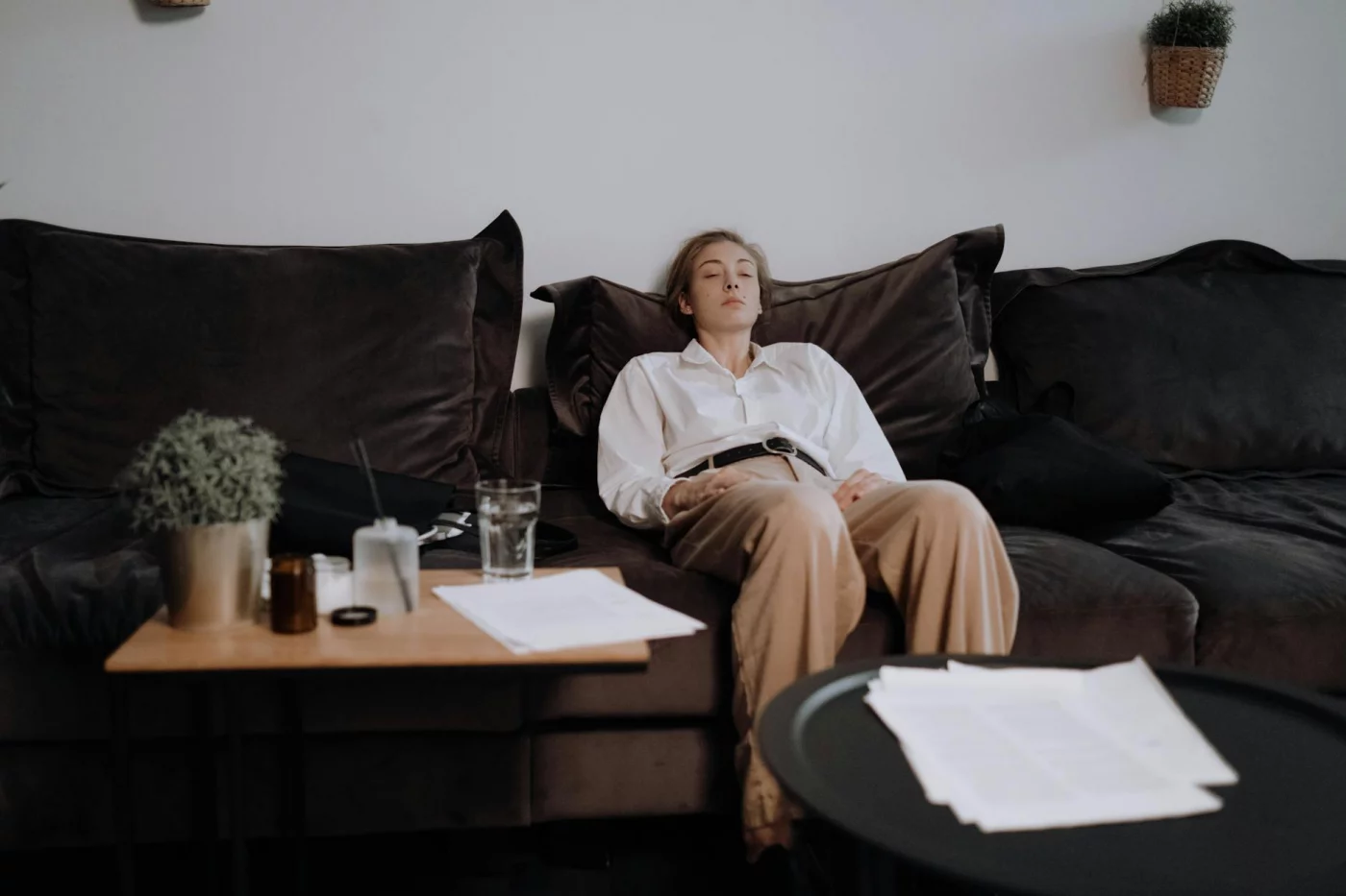 Woman resting on a couch, reflecting on what to do when emotionally exhausted after a draining workday