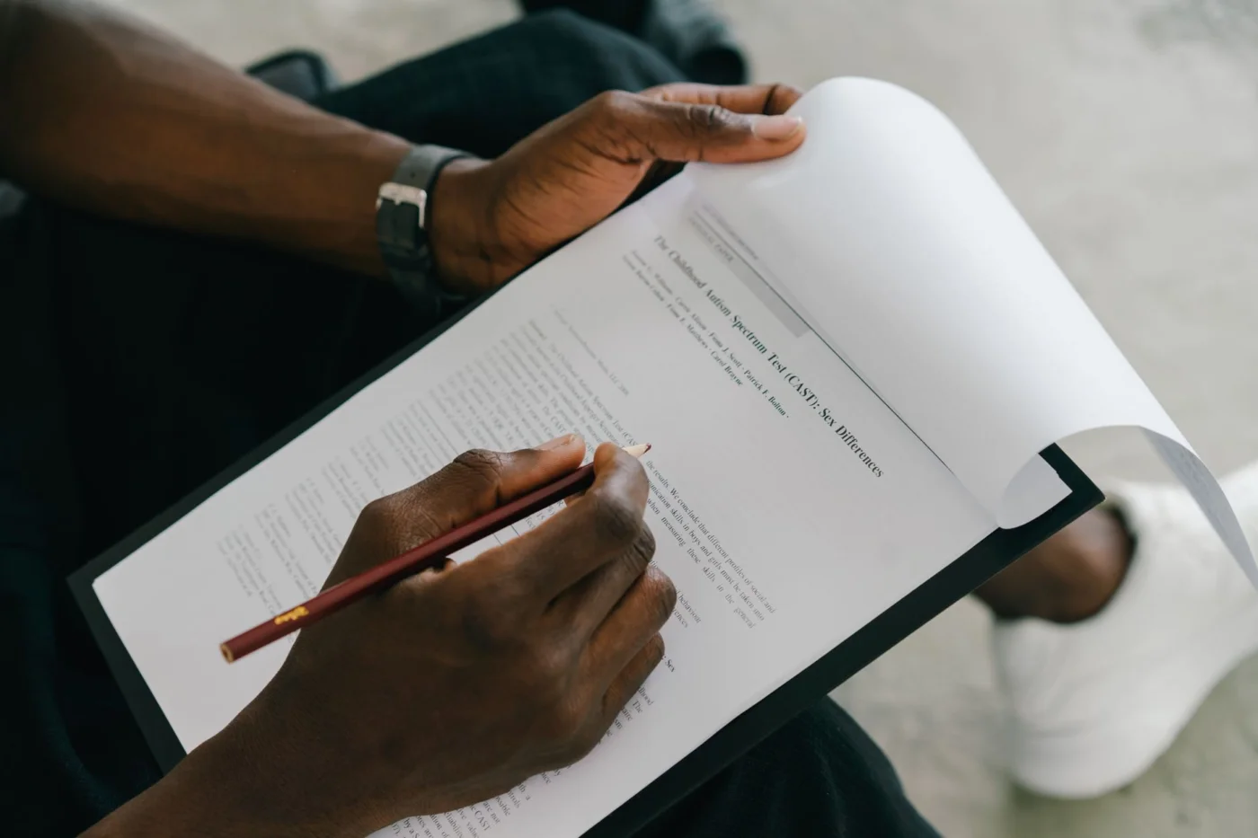 How to Track arXiv Brain and Productivity Papers Without Getting Misled Person completing a psychological assessment form for an FAQ on AI brain study research