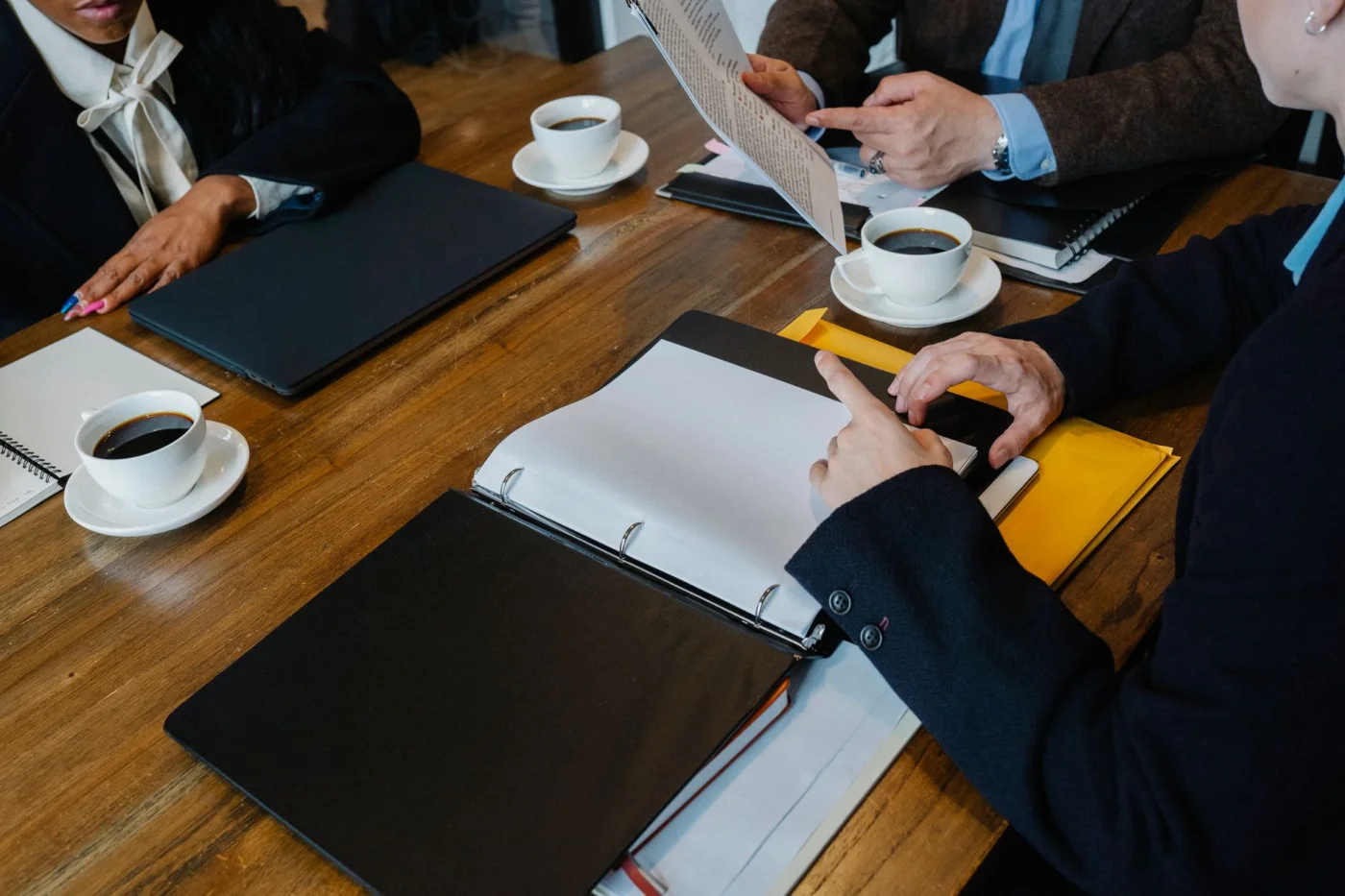 How to Use Neuroscience to Improve Team Communication and Productivity FAQ meeting scene showing how neuroscience improves team communication productivity among coworkers at a table