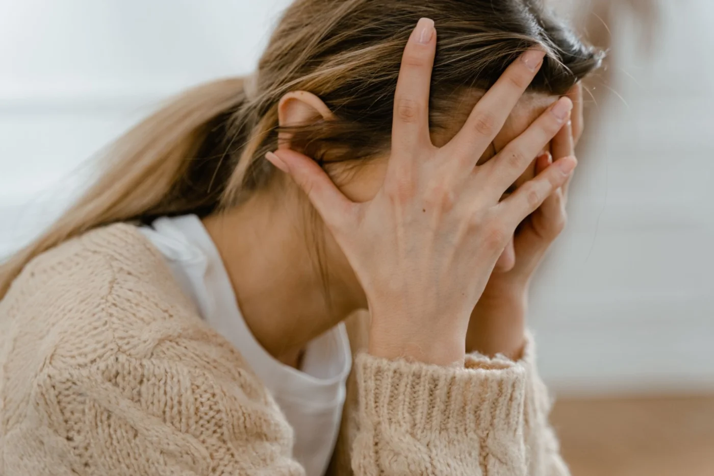Problem-Focused vs Emotion-Focused Coping for Stress and Focus Stressed woman covering her face, illustrating problem focused vs emotion focused coping during overwhelm