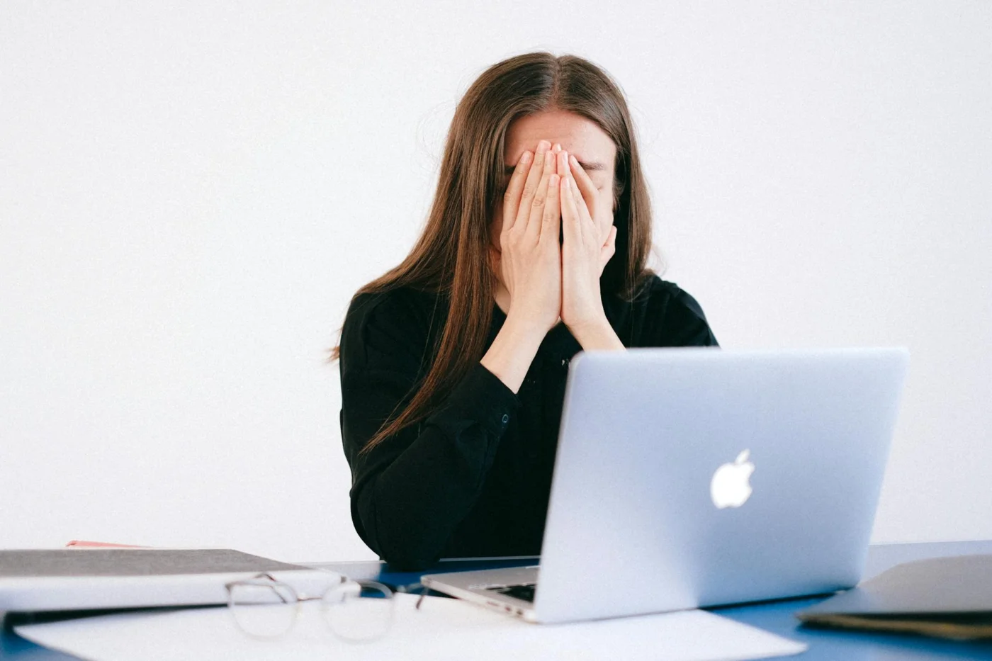 Why You Forget Names Under Stress and How to Improve Recall Stressed remote worker at her desk wondering why am i forgetting names all of a sudden during a mental blank
