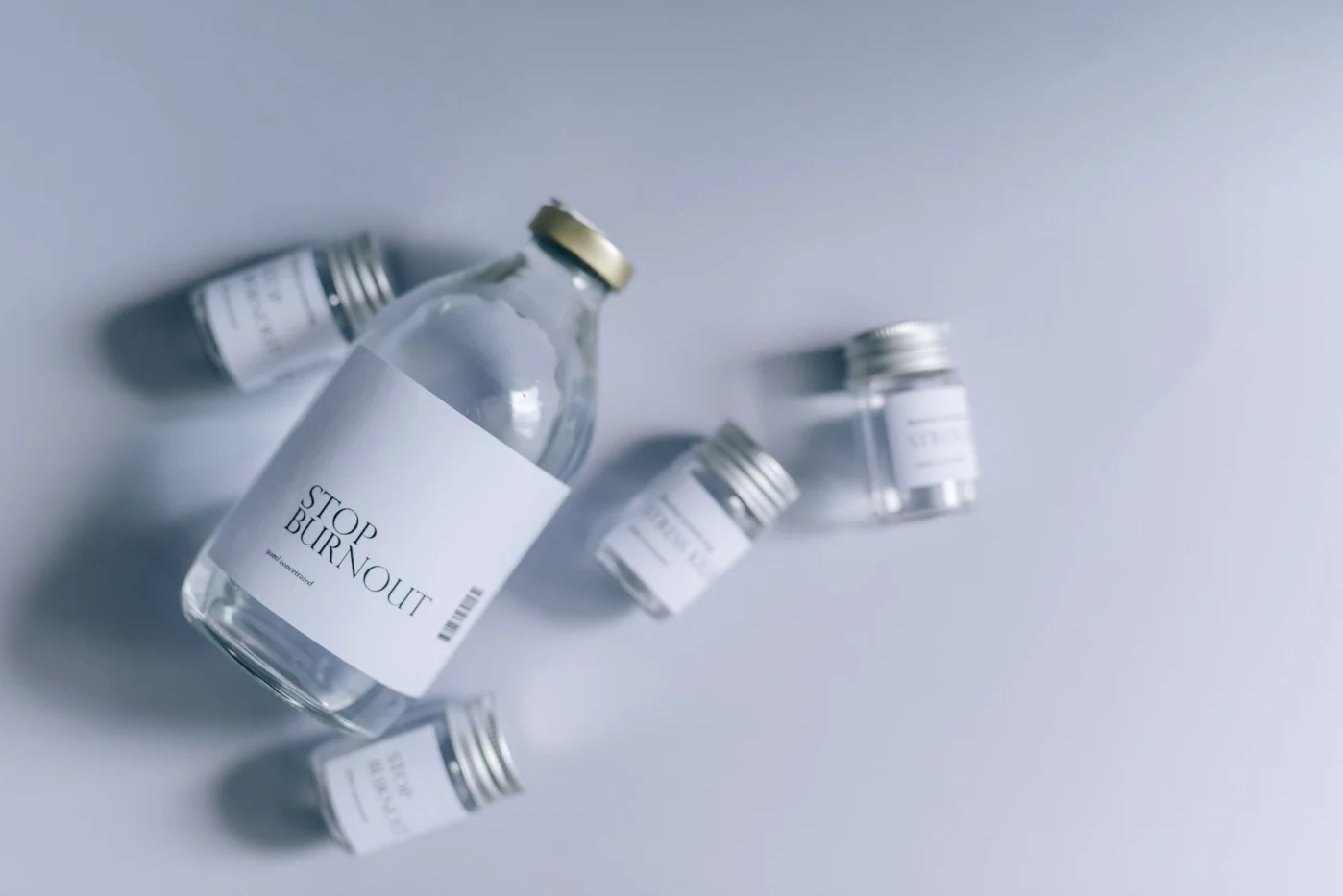 How to Think Clearly When You Feel Stuck and Foggy Glass bottles labeled Stop Burnout showing how to clear brain fog instantly when your brain feels stuck