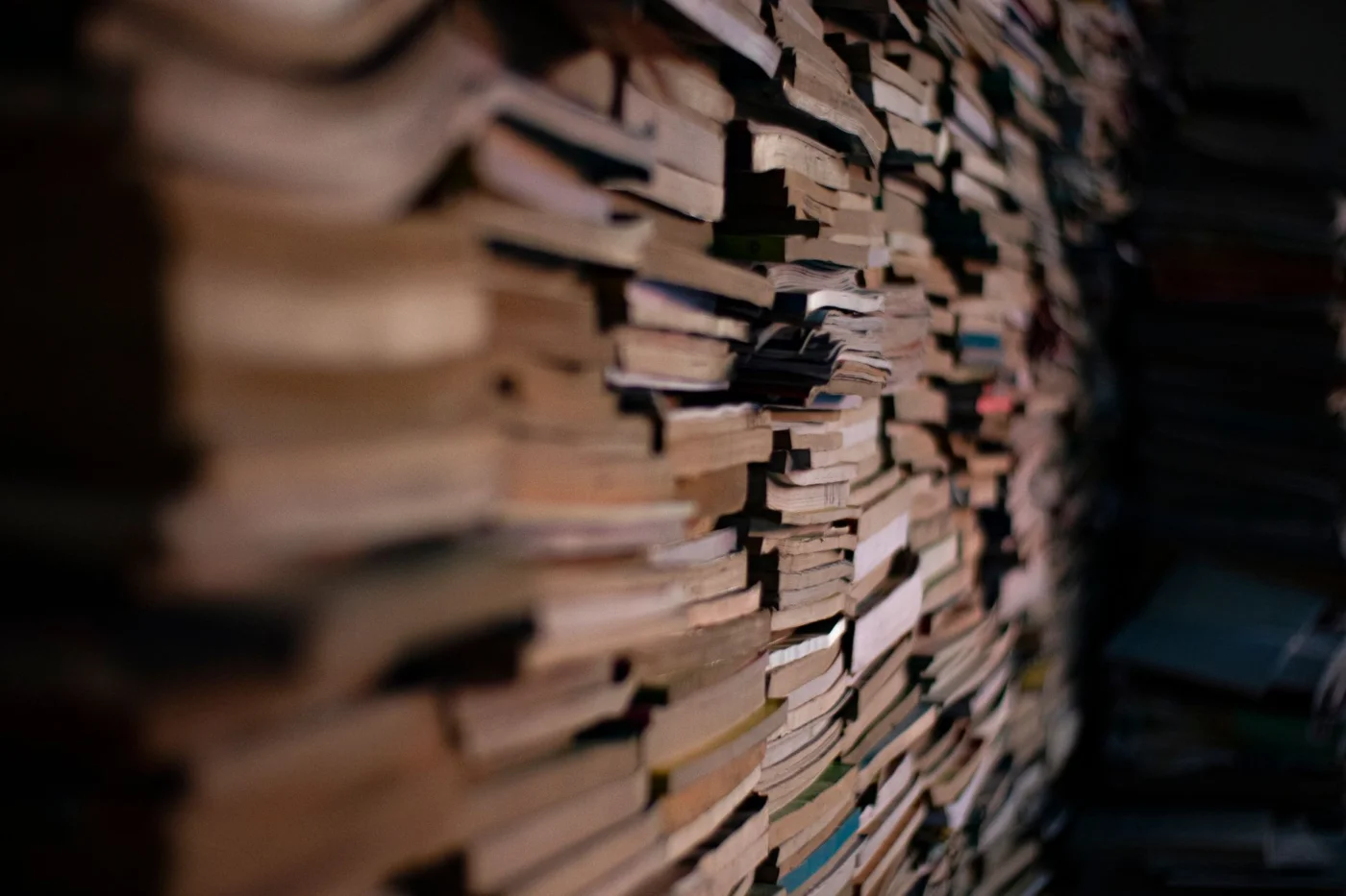 How to Improve Memory for Studying With a Simple Review System Stacked books in a dim study room representing spaced repetition for studying and long-term memory