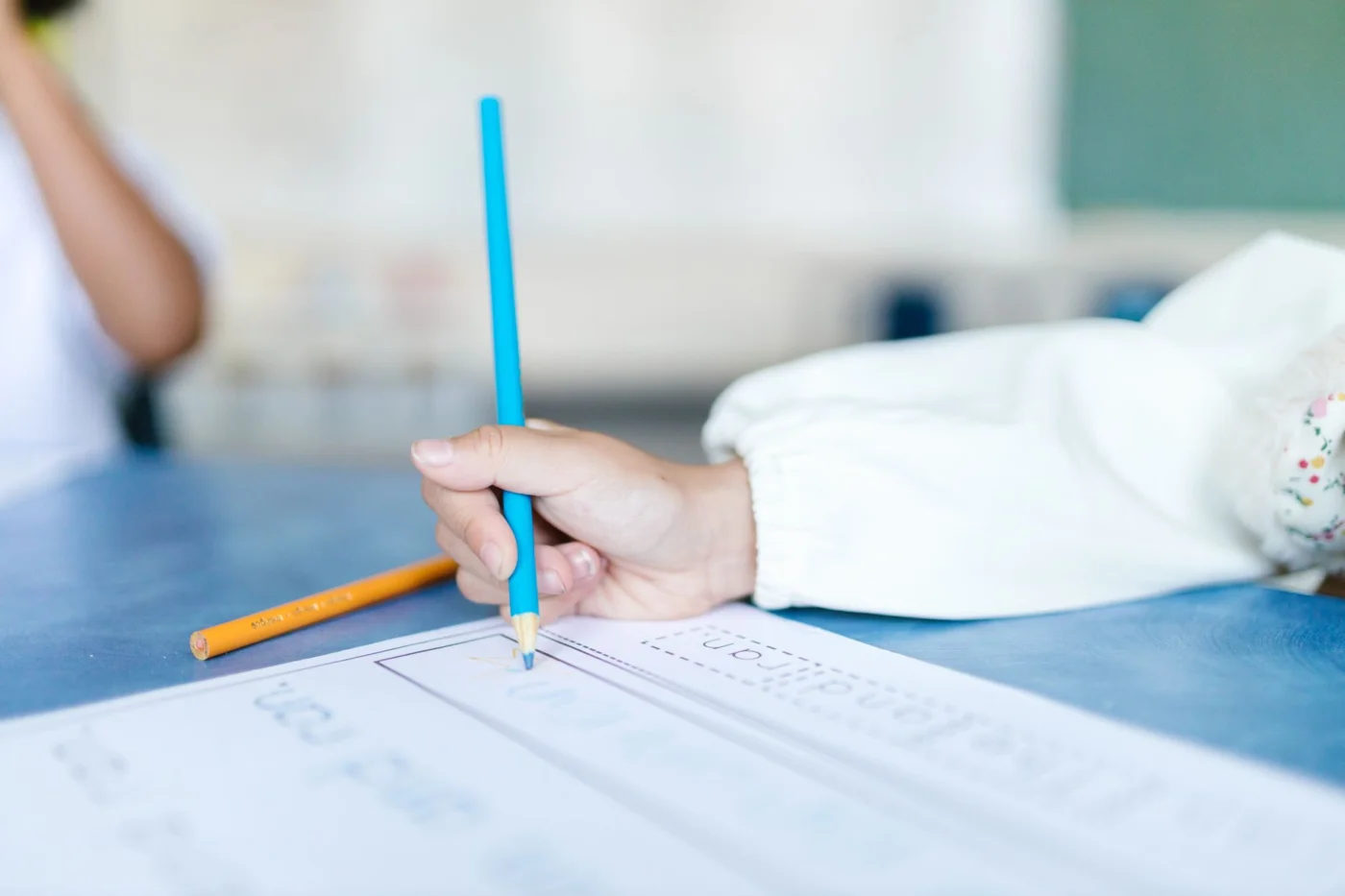 What Motor Learning Theory Says About Practicing Better Child practicing pencil control during a FAQ on what is motor learning theory and fine motor skill development